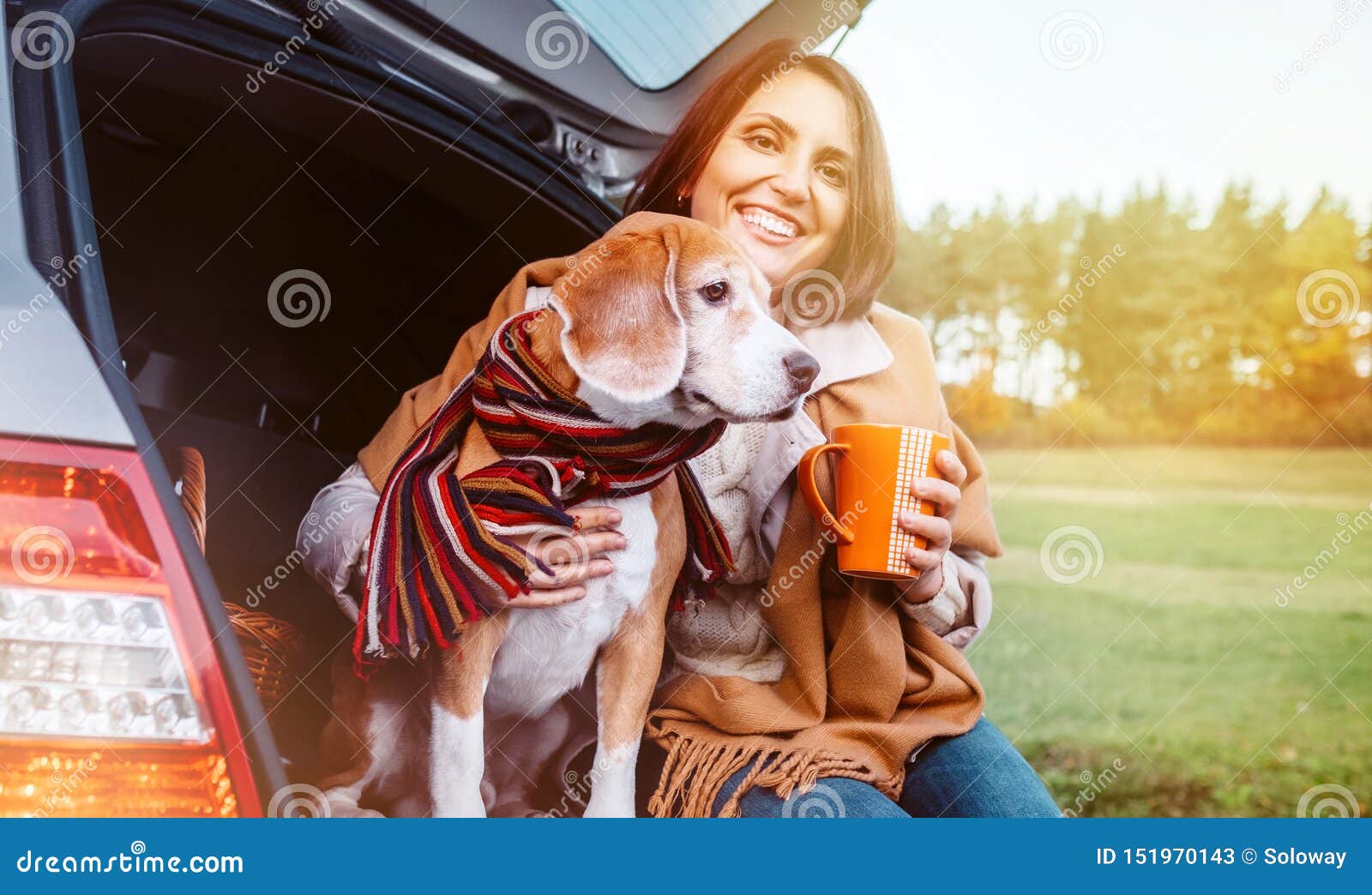 woman with dog sit together in cat truck and warms Ãâ ÃËÃÂµÃâ¬ hot tea. auto travel with pets concept image
